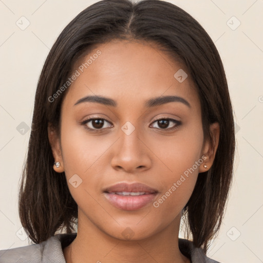 Joyful latino young-adult female with long  brown hair and brown eyes