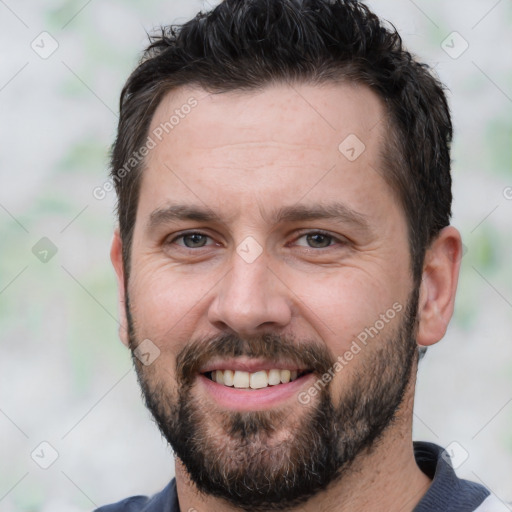 Joyful white adult male with short  brown hair and brown eyes