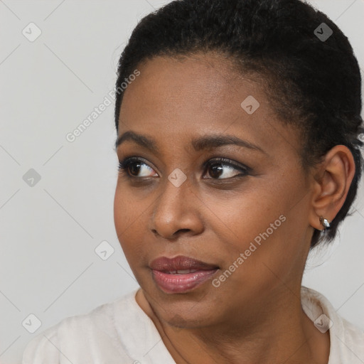 Joyful black young-adult female with short  black hair and brown eyes