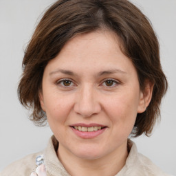 Joyful white adult female with medium  brown hair and brown eyes