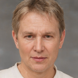 Joyful white middle-aged male with short  brown hair and brown eyes