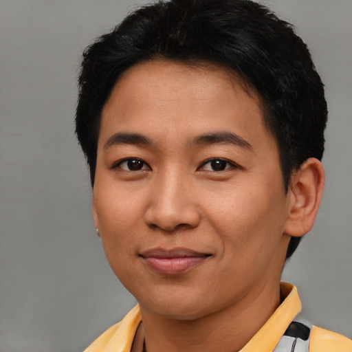 Joyful asian young-adult male with short  brown hair and brown eyes