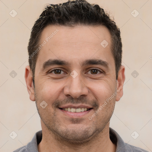 Joyful white young-adult male with short  black hair and brown eyes