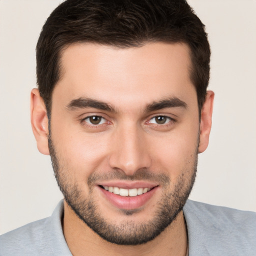 Joyful white young-adult male with short  brown hair and brown eyes