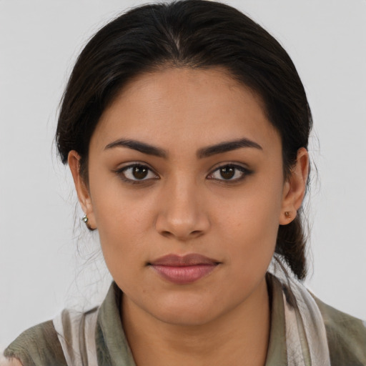 Joyful latino young-adult female with medium  brown hair and brown eyes