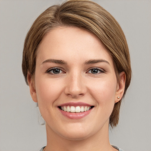 Joyful white young-adult female with medium  brown hair and grey eyes