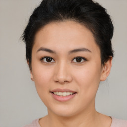 Joyful asian young-adult female with short  brown hair and brown eyes