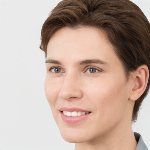 Joyful white young-adult female with short  brown hair and grey eyes