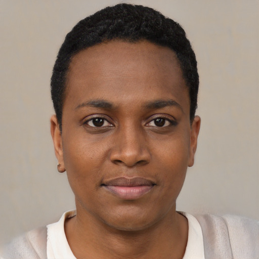 Joyful black young-adult female with short  black hair and brown eyes