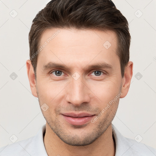 Joyful white young-adult male with short  brown hair and brown eyes