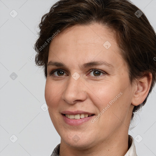 Joyful white adult female with short  brown hair and grey eyes