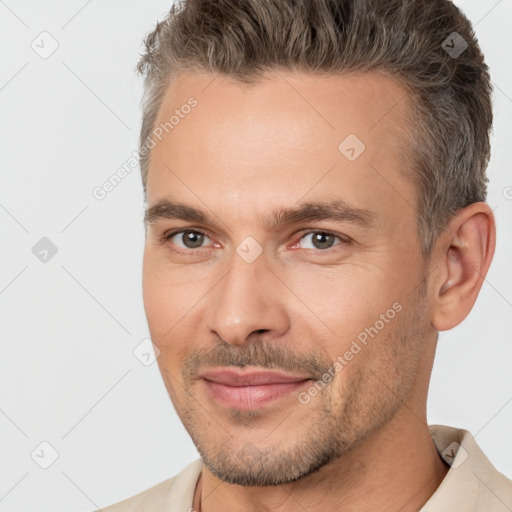 Joyful white adult male with short  brown hair and brown eyes