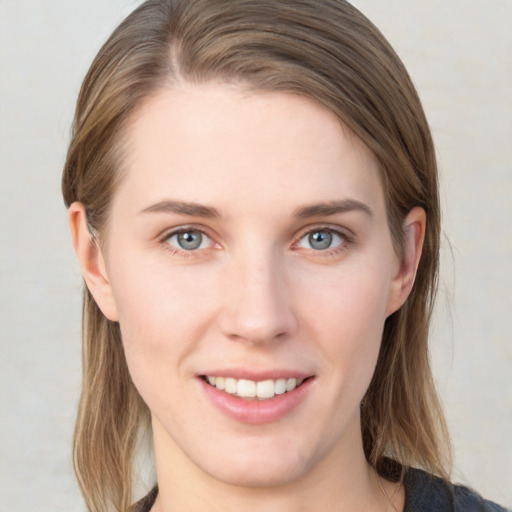 Joyful white young-adult female with medium  brown hair and blue eyes