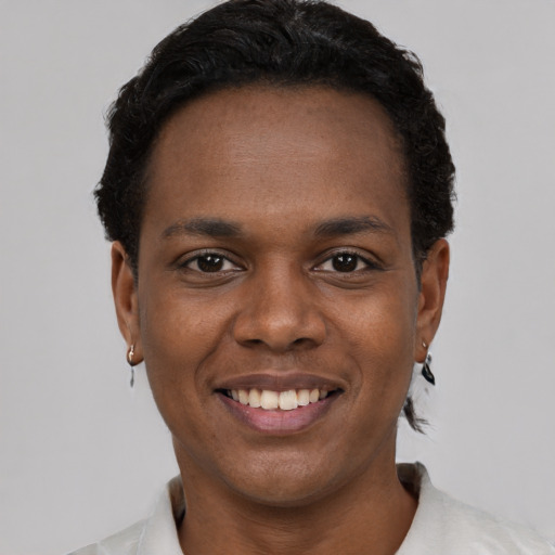 Joyful black young-adult male with short  brown hair and brown eyes