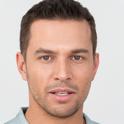 Joyful white young-adult male with short  brown hair and brown eyes