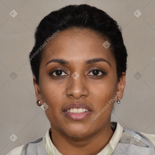 Joyful black young-adult female with short  black hair and brown eyes