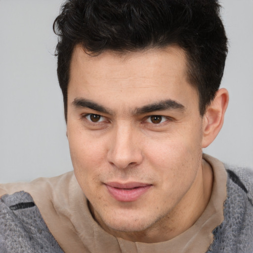 Joyful latino young-adult male with short  brown hair and brown eyes