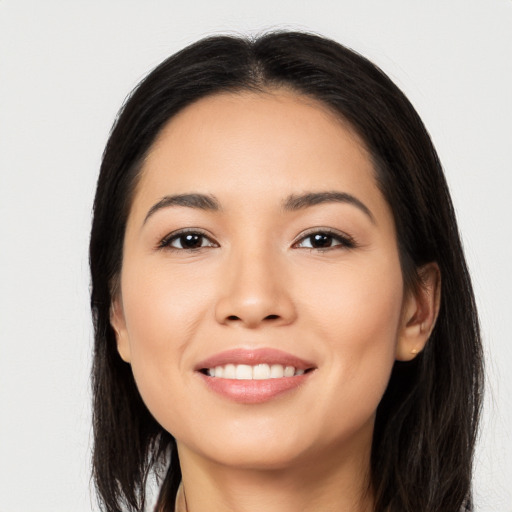 Joyful latino young-adult female with long  black hair and brown eyes