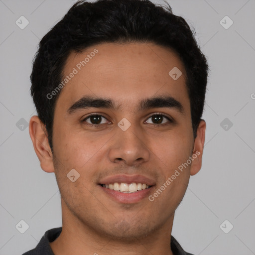 Joyful latino young-adult male with short  black hair and brown eyes