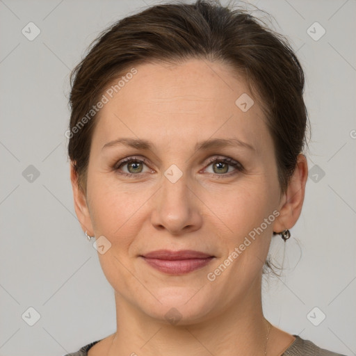 Joyful white adult female with short  brown hair and grey eyes