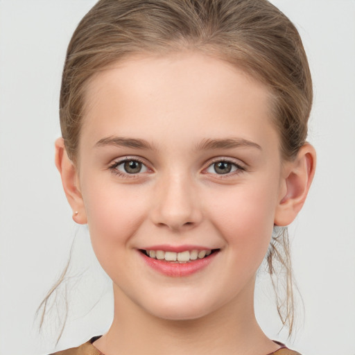 Joyful white child female with medium  brown hair and grey eyes