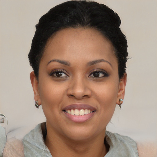 Joyful black young-adult female with short  black hair and brown eyes