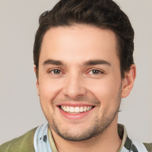 Joyful white young-adult male with short  brown hair and brown eyes