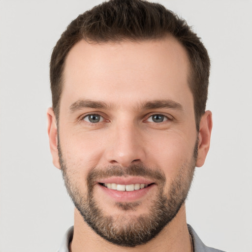 Joyful white young-adult male with short  brown hair and brown eyes