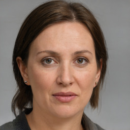 Joyful white adult female with medium  brown hair and brown eyes