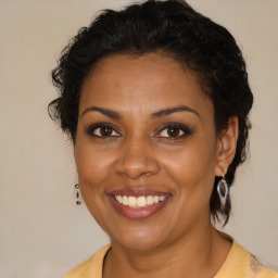 Joyful black young-adult female with medium  brown hair and brown eyes