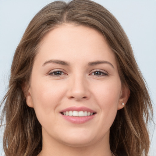 Joyful white young-adult female with long  brown hair and grey eyes