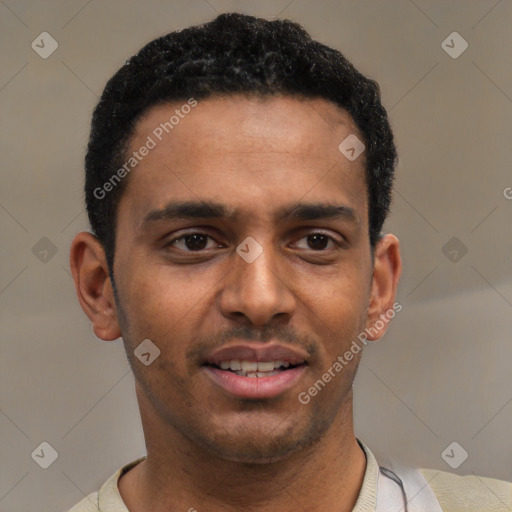 Joyful black young-adult male with short  black hair and brown eyes