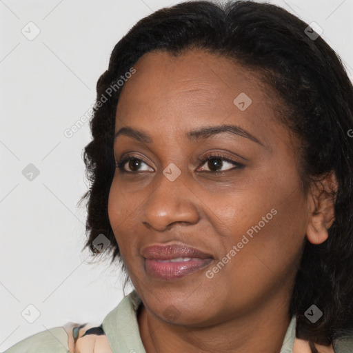 Joyful black adult female with medium  brown hair and brown eyes