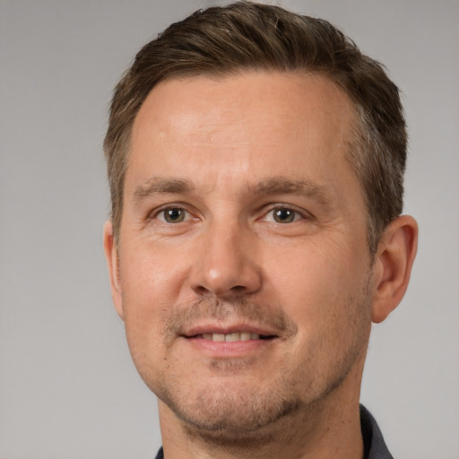 Joyful white adult male with short  brown hair and brown eyes