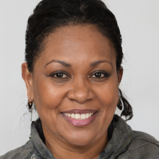 Joyful black adult female with short  brown hair and brown eyes