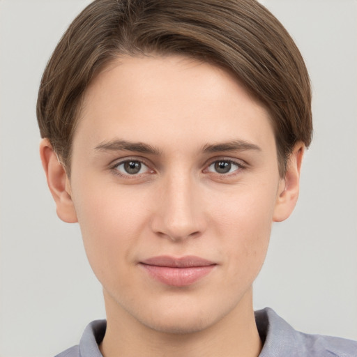 Joyful white young-adult female with short  brown hair and grey eyes