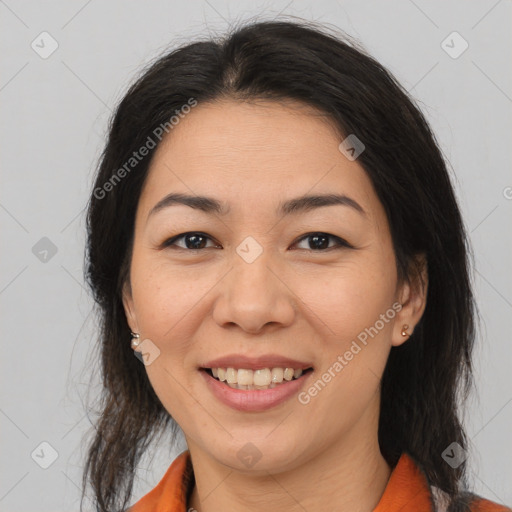 Joyful asian adult female with medium  brown hair and brown eyes