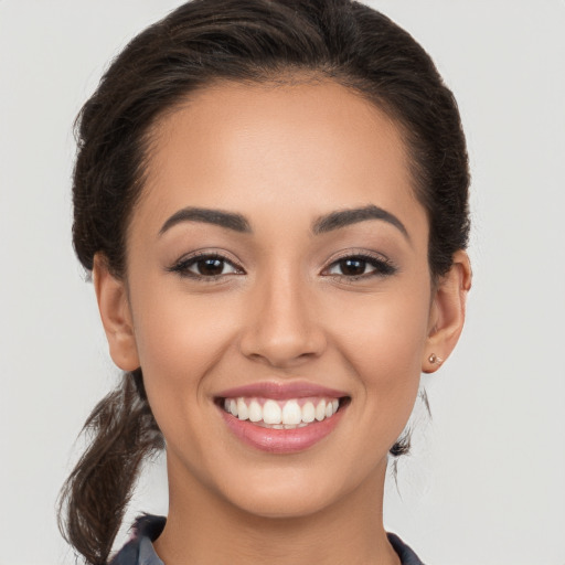 Joyful white young-adult female with long  brown hair and brown eyes