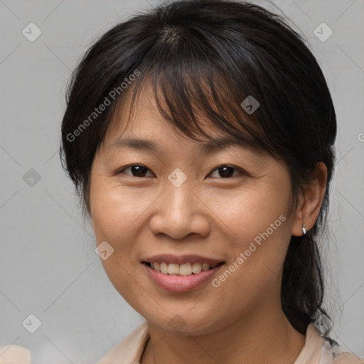 Joyful white adult female with medium  brown hair and brown eyes