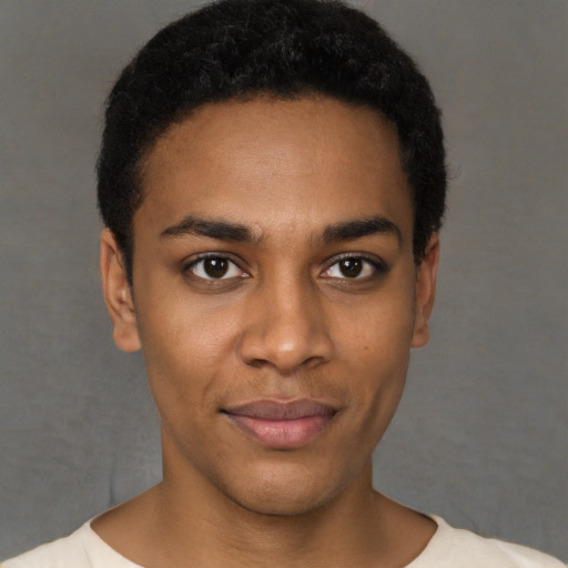 Joyful black young-adult male with short  black hair and brown eyes