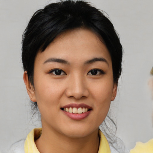 Joyful asian young-adult female with medium  brown hair and brown eyes