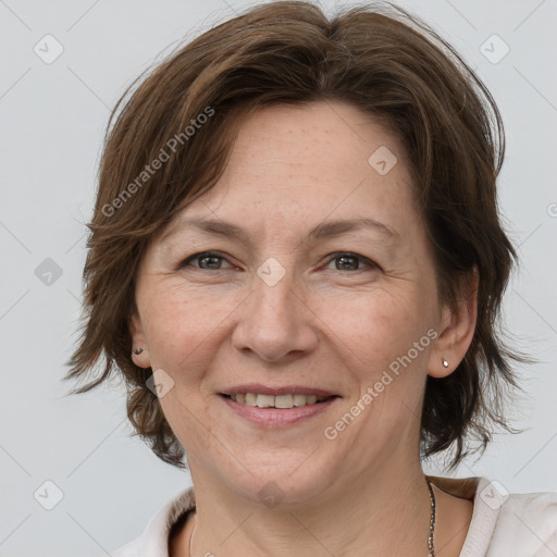 Joyful white adult female with medium  brown hair and grey eyes