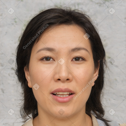 Joyful asian adult female with medium  brown hair and brown eyes