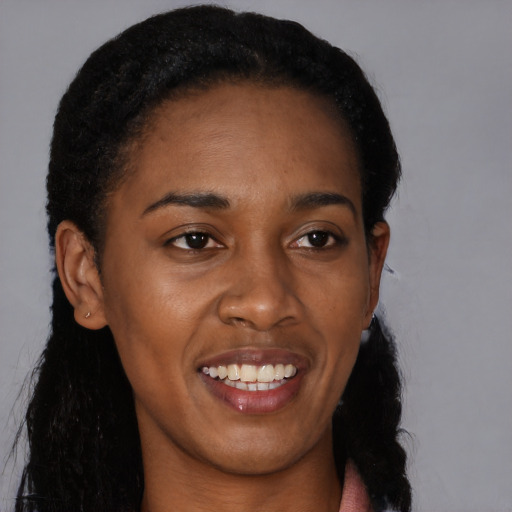 Joyful black young-adult female with long  black hair and brown eyes