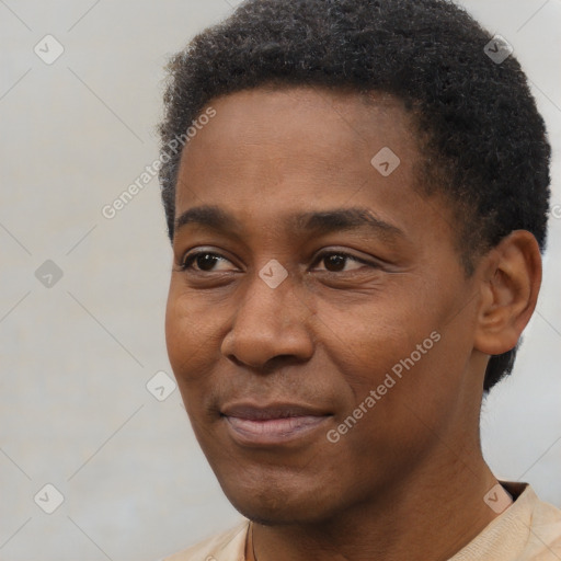 Joyful black young-adult male with short  black hair and brown eyes