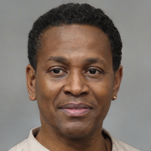Joyful black adult male with short  black hair and brown eyes