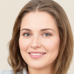 Joyful white young-adult female with medium  brown hair and green eyes