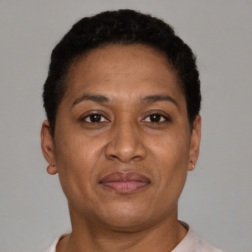 Joyful latino adult female with short  brown hair and brown eyes