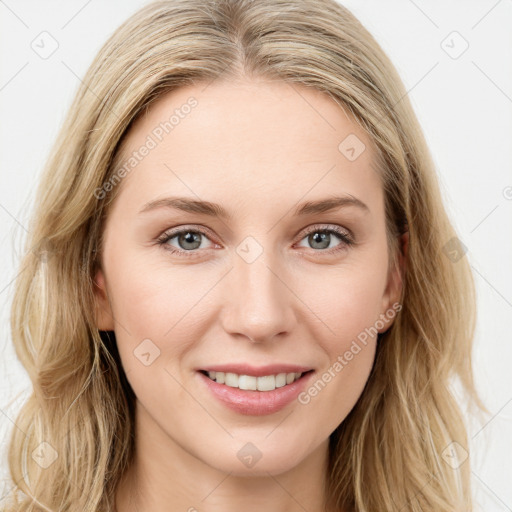 Joyful white young-adult female with long  brown hair and blue eyes