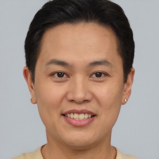 Joyful asian young-adult male with short  brown hair and brown eyes